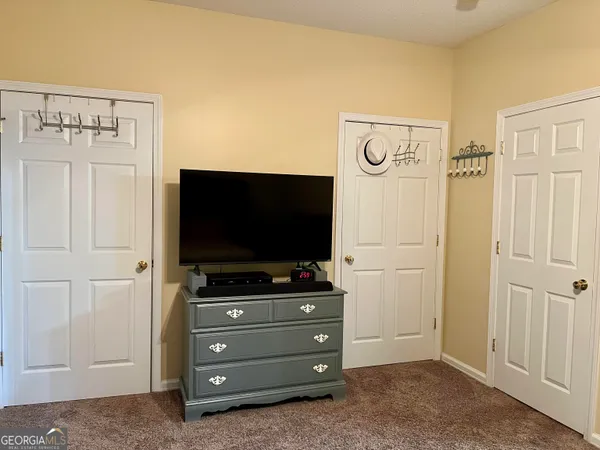 a room with a bed and cabinets