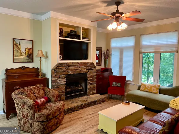 a living room with furniture a chandelier and a large window