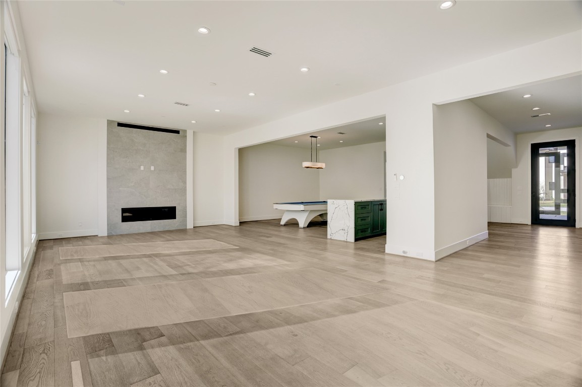 6533 Corbin Street Houston, TX 77055 - Photo 11 of 50 a view of an empty room with wooden floor and a fireplace