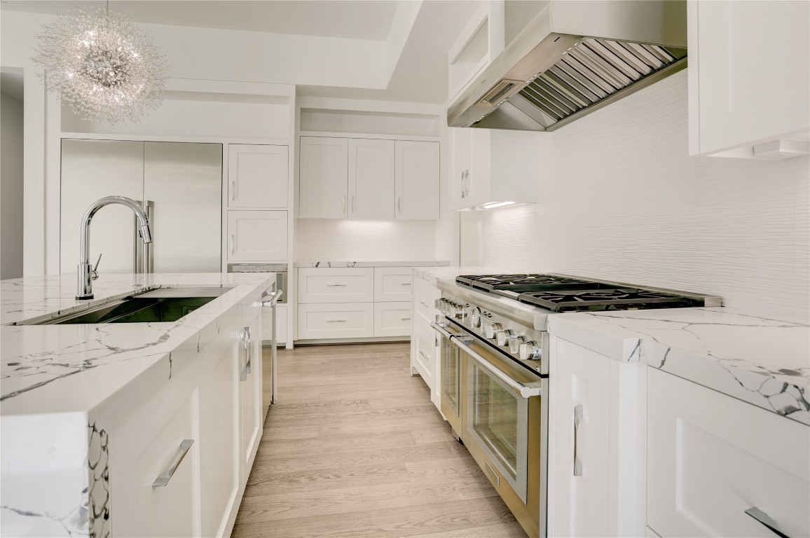 6533 Corbin Street Houston, TX 77055 - Photo 20 of 50 a kitchen with a white cabinets stove and sink