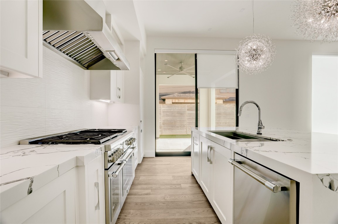 6533 Corbin Street Houston, TX 77055 - Photo 23 of 50 a kitchen with stainless steel appliances granite countertop a stove and a sink