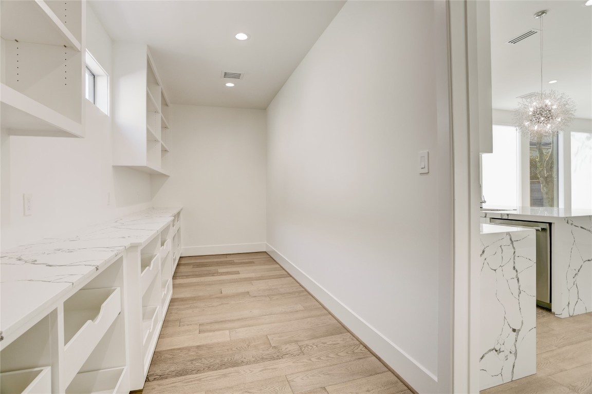 6533 Corbin Street Houston, TX 77055 - Photo 24 of 50 a view of a hallway with wooden floor and staircase