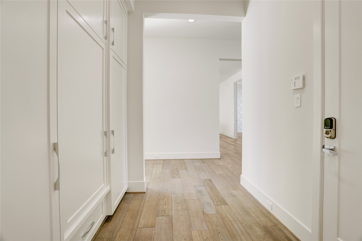 6533 Corbin Street Houston, TX 77055 - Photo 26 of 50 a view of a hallway with wooden floor and staircase