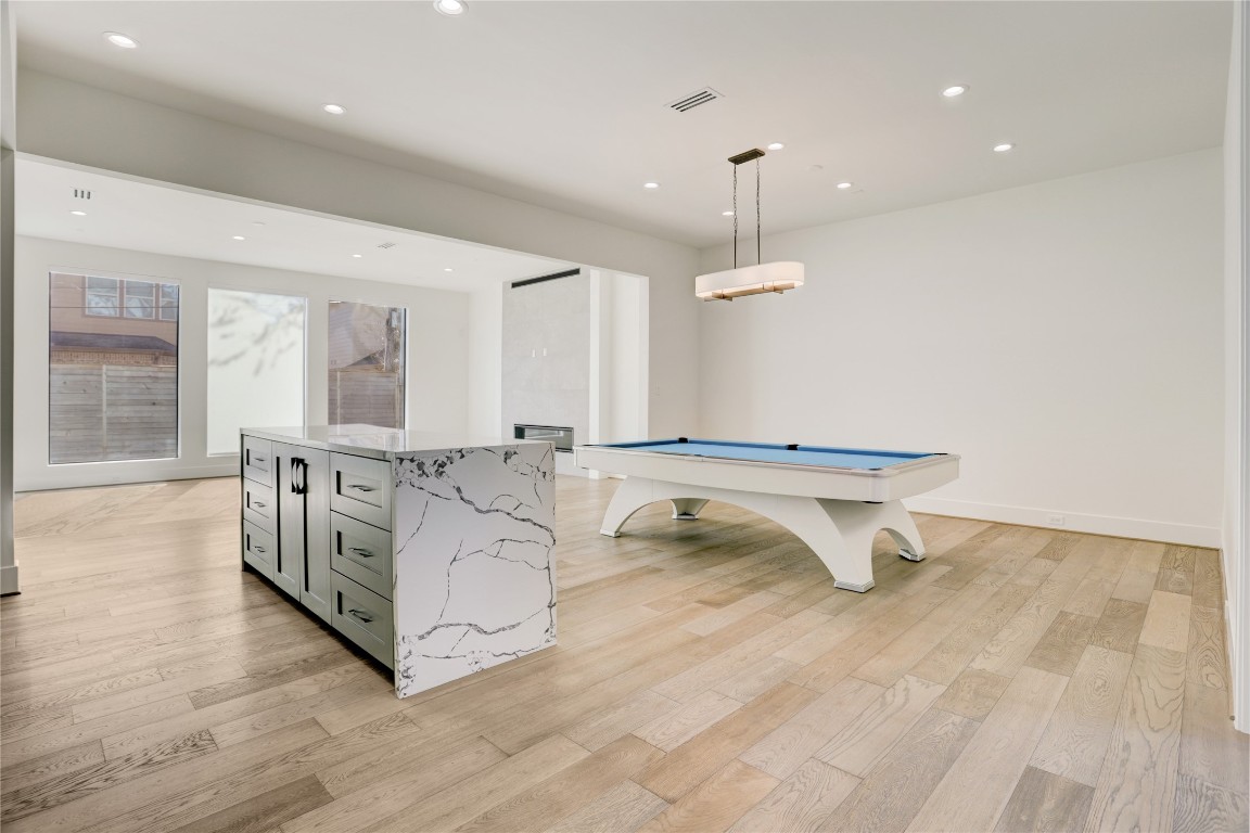 6533 Corbin Street Houston, TX 77055 - Photo 4 of 50 a living room with kitchen island a sink and a wooden floor