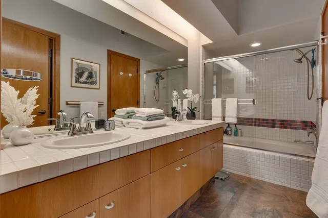 a bathroom with a double vanity sink mirror and double