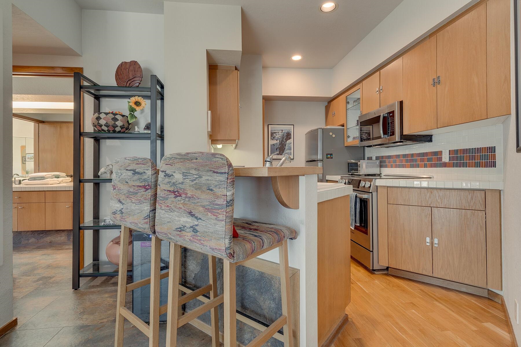 201 Shirley Cyn Road, Unit 302 Olympic Valley, CA 96146 - Photo 15 of 28 a kitchen with cabinets and chairs