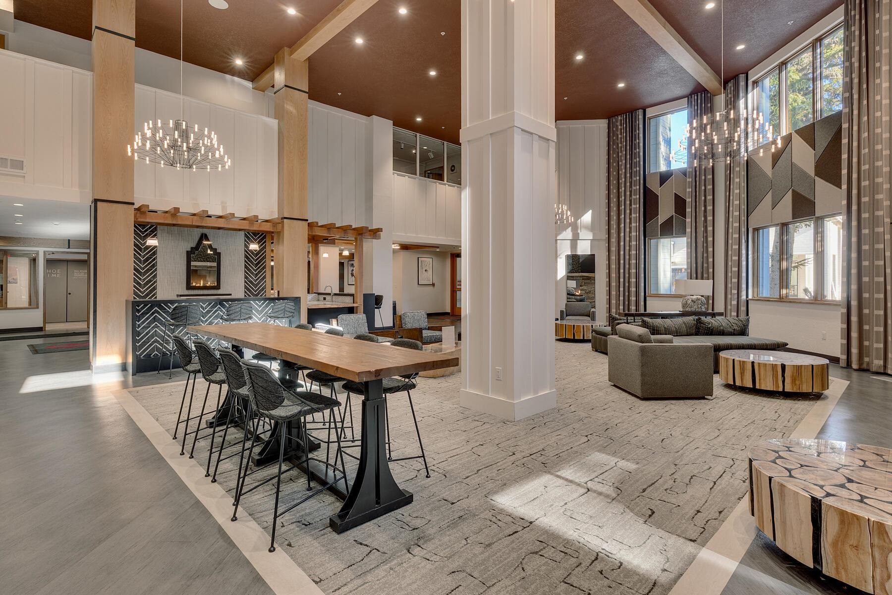 201 Shirley Cyn Road, Unit 302 Olympic Valley, CA 96146 - Photo 16 of 28 a kitchen with stainless steel appliances kitchen island granite countertop a table chairs in it and wooden floors