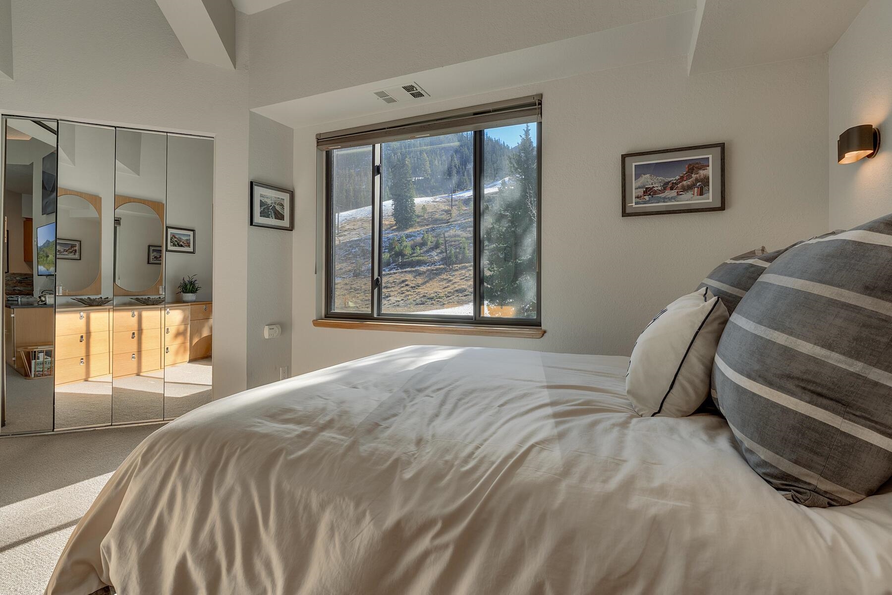 201 Shirley Cyn Road, Unit 302 Olympic Valley, CA 96146 - Photo 18 of 28 a bed sitting in a bedroom next to a window