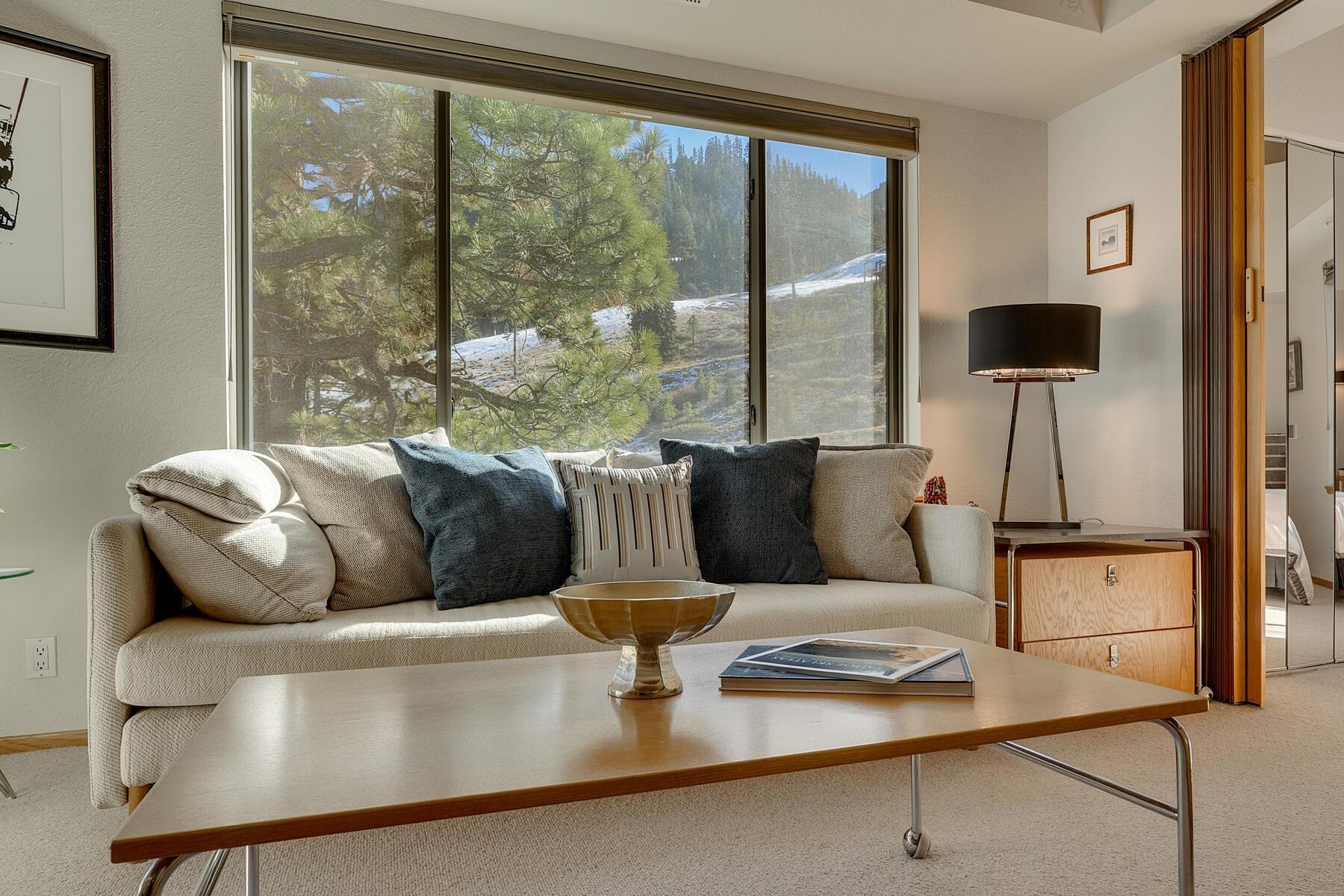 201 Shirley Cyn Road, Unit 302 Olympic Valley, CA 96146 - Photo 2 of 28 a living room with furniture and a floor to ceiling window