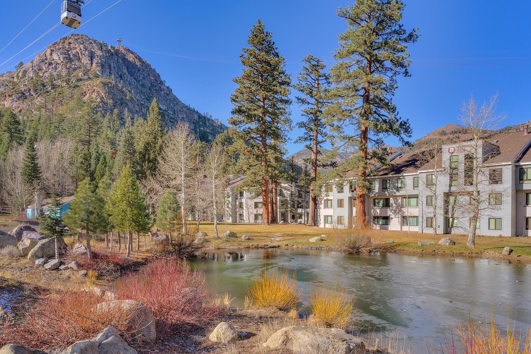 201 Shirley Cyn Road, Unit 302 Olympic Valley, CA 96146 - Photo 23 of 28 a view of a lake with a building in the background
