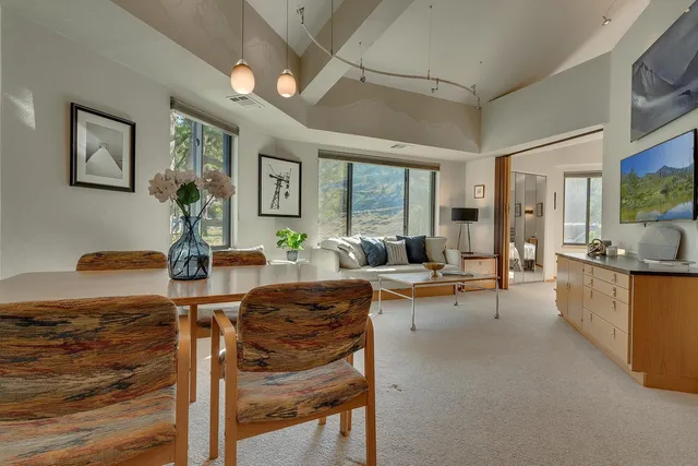 a living room with fireplace furniture and a large window