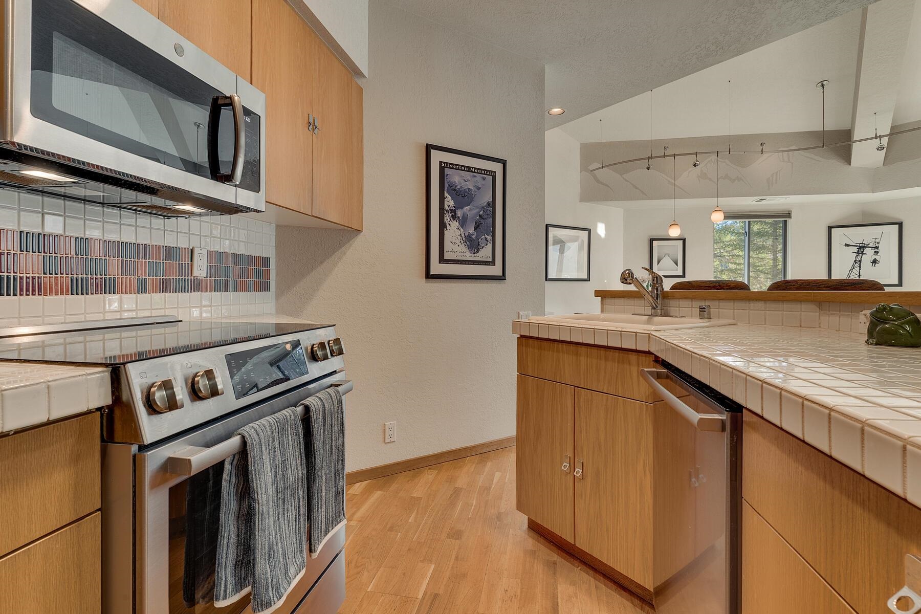 201 Shirley Cyn Road, Unit 302 Olympic Valley, CA 96146 - Photo 6 of 28 a kitchen with stainless steel appliances granite countertop a stove and a sink