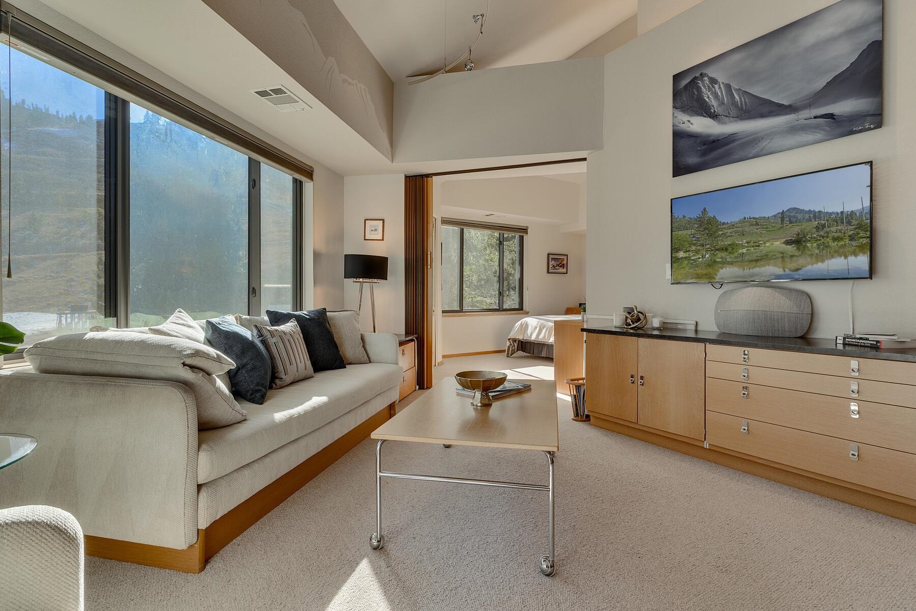 201 Shirley Cyn Road, Unit 302 Olympic Valley, CA 96146 - Photo 8 of 28 a living room with furniture and a flat screen tv