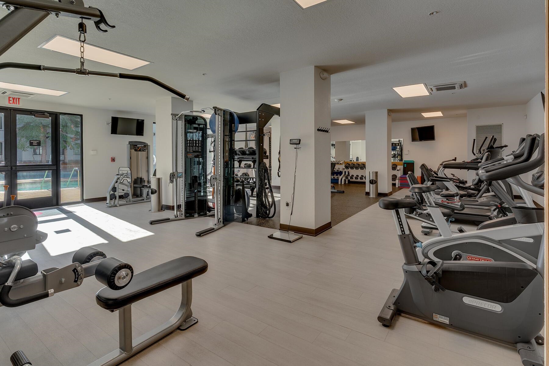 201 Shirley Cyn Road, Unit 302 Olympic Valley, CA 96146 - Photo 9 of 28 a room with gym equipment and a chandelier
