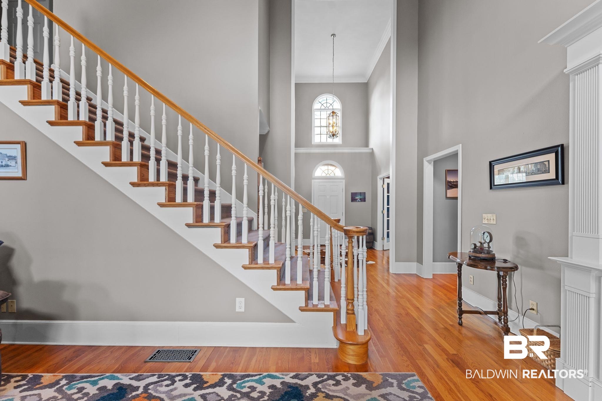 525 Norwood Road Monroeville, AL 36460 - Photo 28 of 55 Foyer entrance with light wood finished floors, ornamental molding, a high ceiling, stairway, and a chandelier