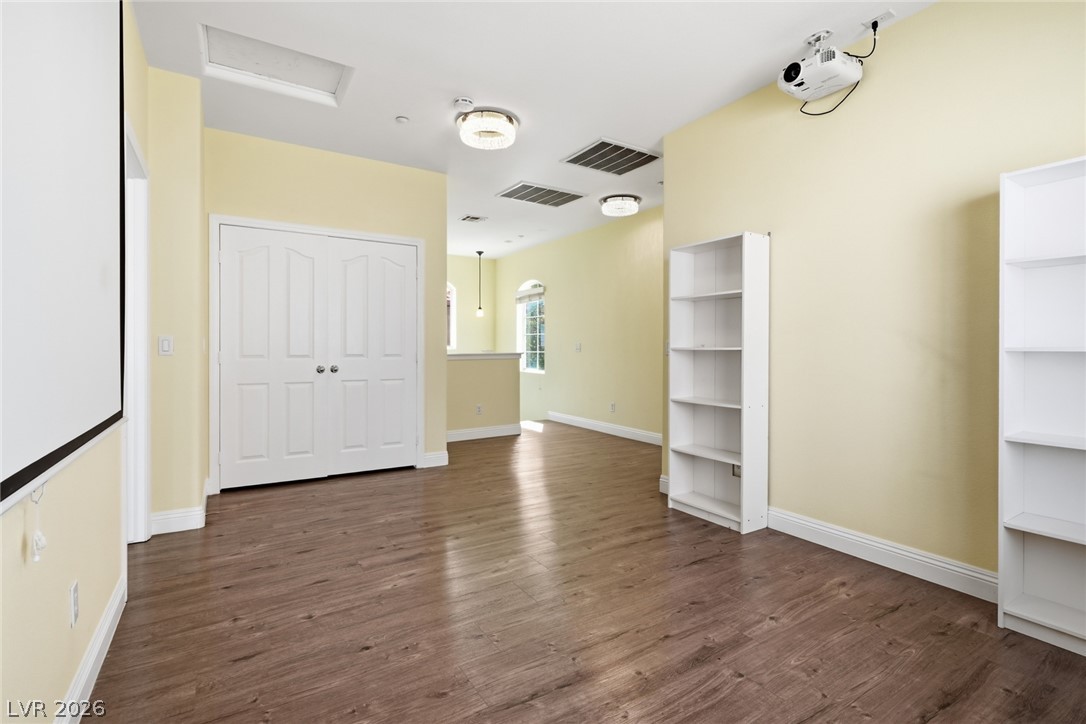 8932 Caledon Ridge Court Las Vegas, NV 89149 - Photo 24 of 39 Rich wood-inspired flooring pairs with light walls and classic trim under a smooth plaster ceiling.