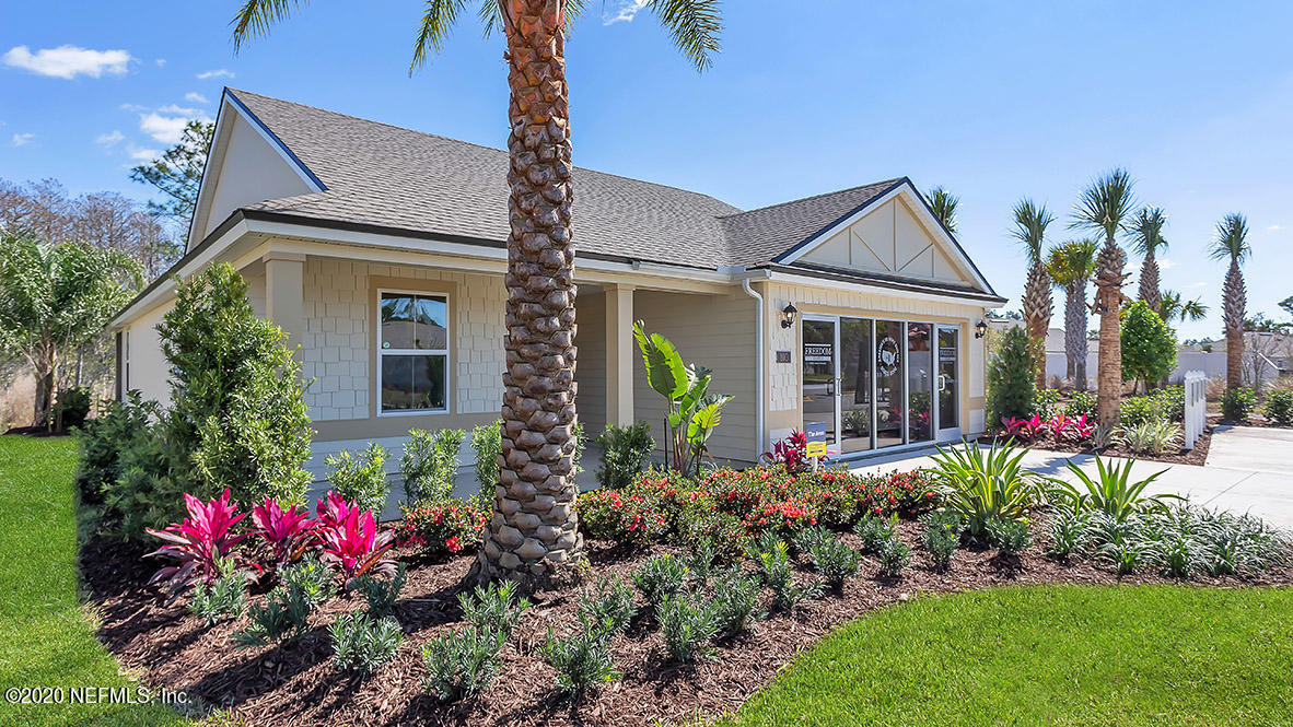 a front view of a house with a yard and fountain