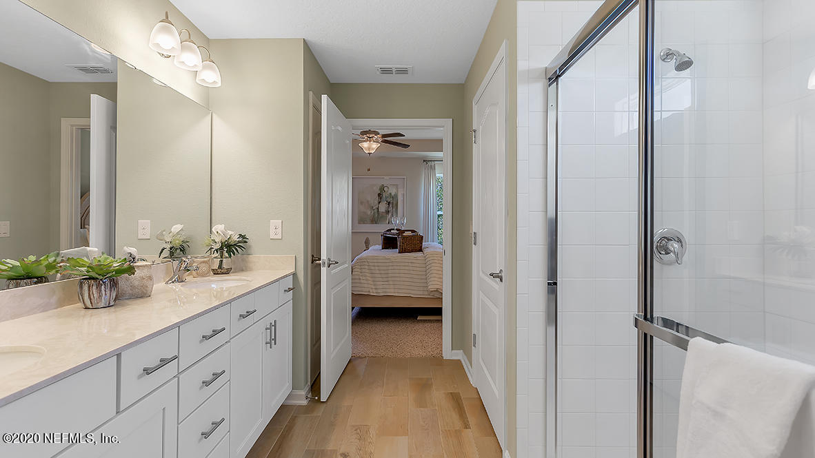 100 Palace Drive St. Augustine, FL 32084 - Photo 13 of 27 a en suite bathroom with a double vanity sink and mirror
