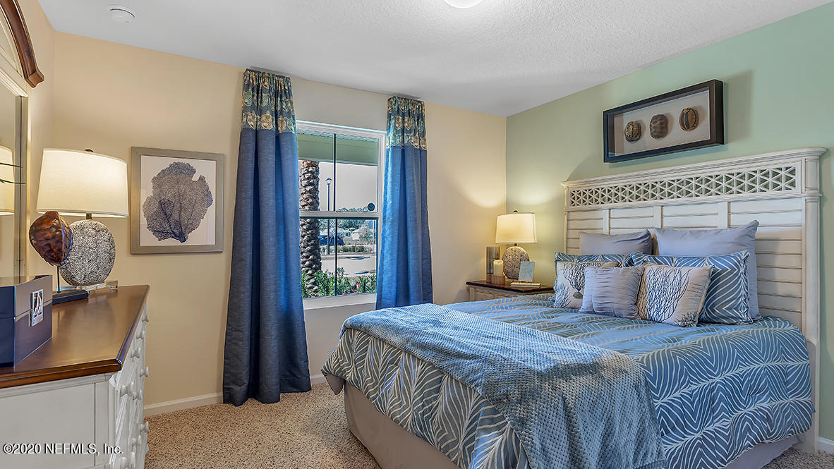 100 Palace Drive St. Augustine, FL 32084 - Photo 9 of 27 a bedroom with a large bed and a window