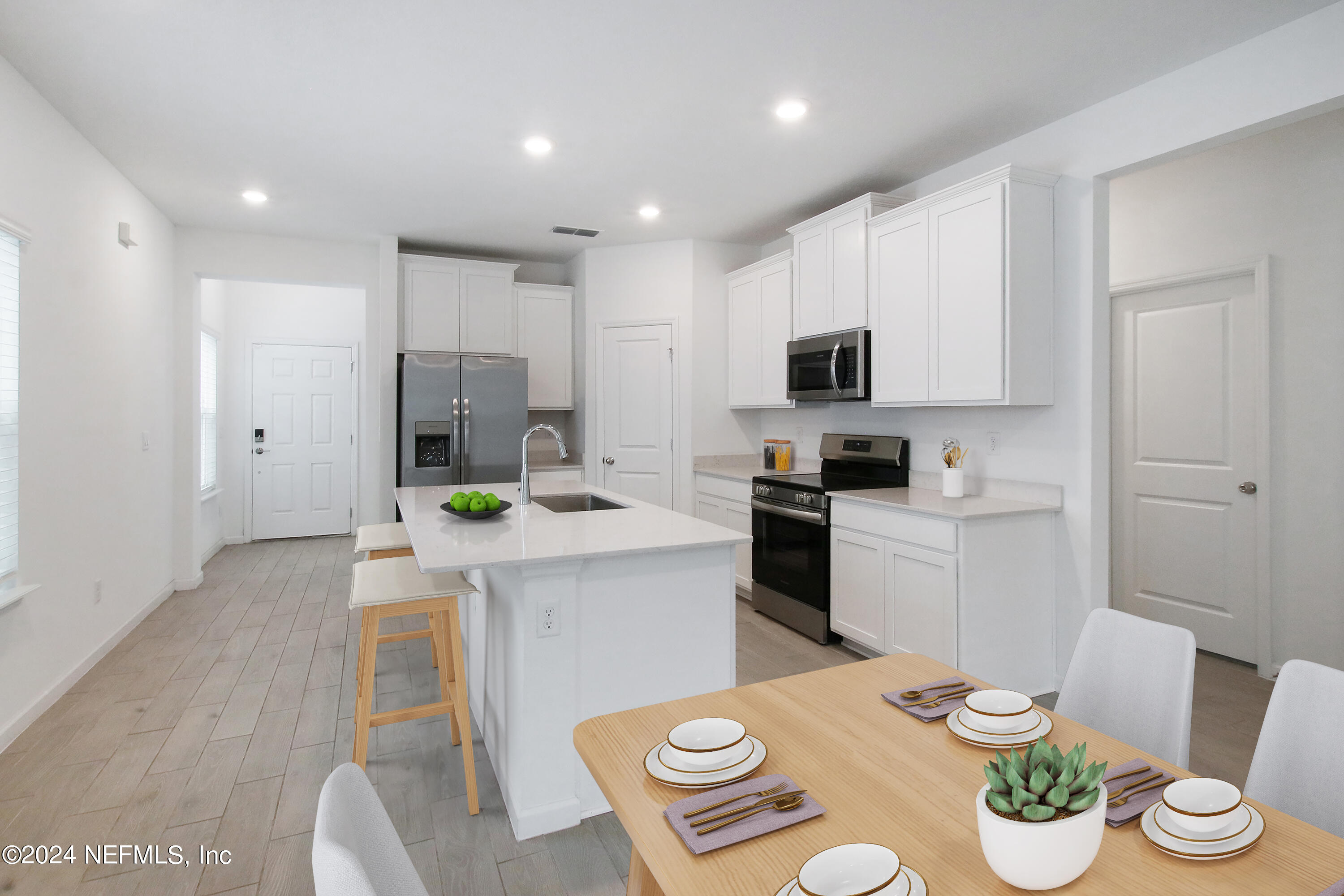 45 Walloon Cove St. Augustine, FL 32092 - Photo 19 of 32 a kitchen that has stainless steel appliances a table and chairs in it
