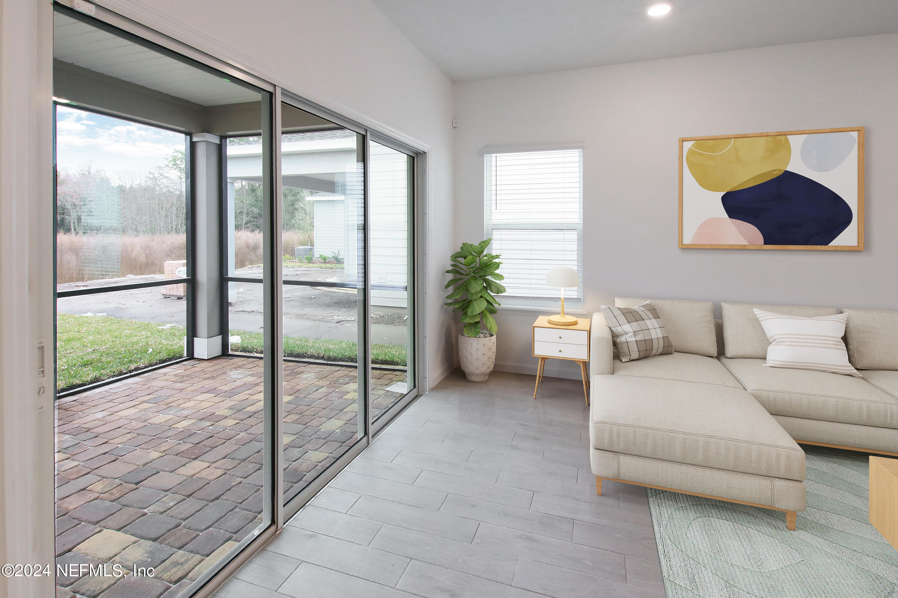 45 Walloon Cove St. Augustine, FL 32092 - Photo 21 of 32 a living room with furniture and a floor to ceiling window