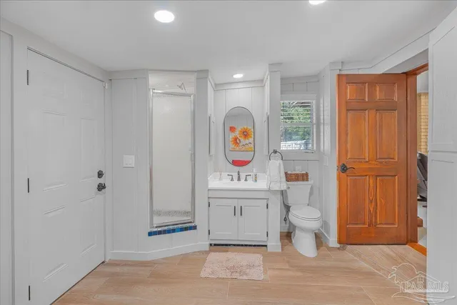 a spacious bathroom with a sink mirror vanity and toilet