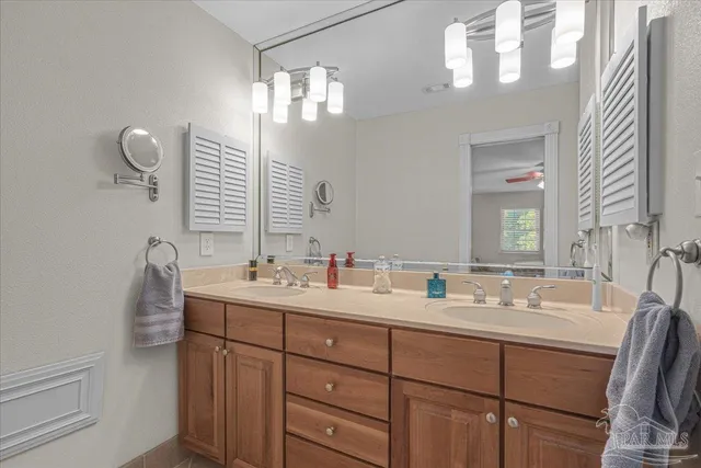 a bathroom with a double vanity sink and a mirror