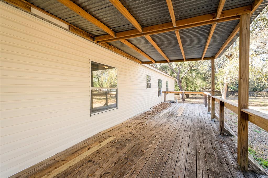 16314 Tiger Trail Spring Hill, FL 34610 - Photo 39 of 43 a view of a porch with wooden floor and outdoor space