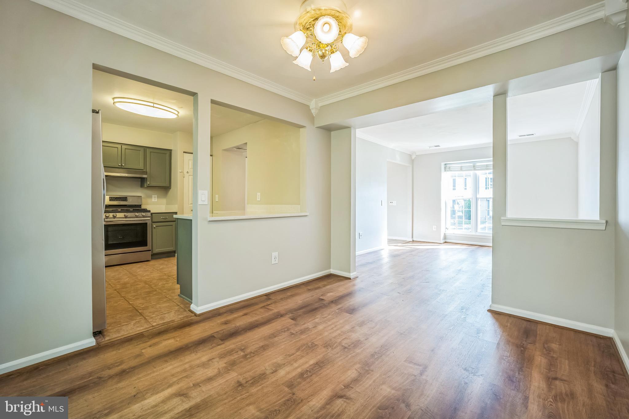 14801 Basingstoke Loop Centreville, VA 20120 - Photo 11 of 28 wooden floor in an empty room with a window