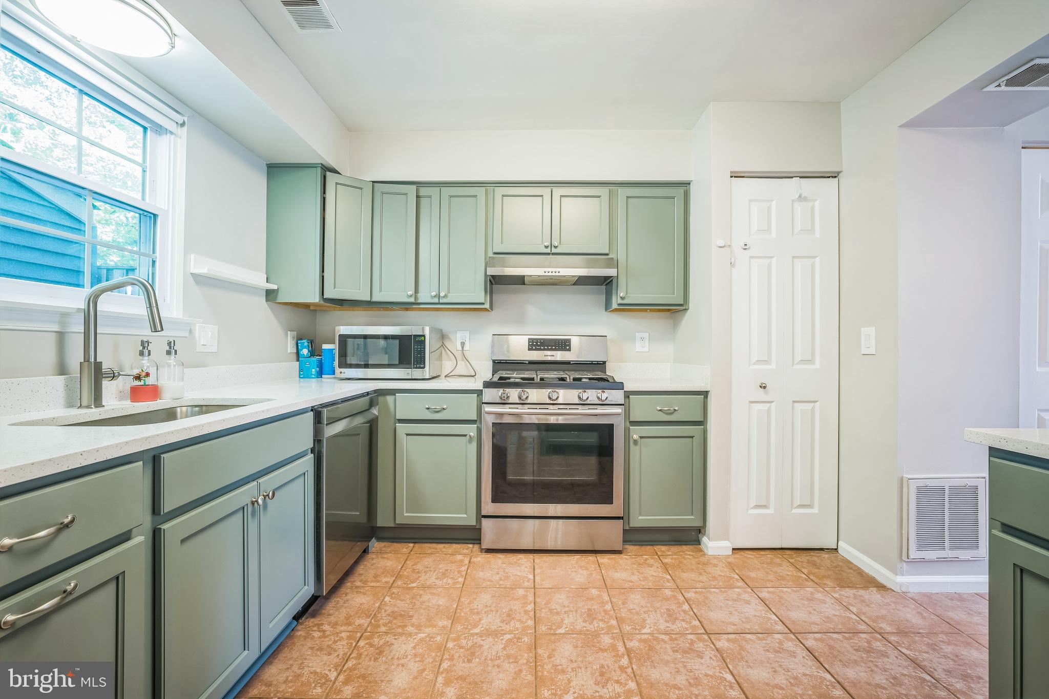 14801 Basingstoke Loop Centreville, VA 20120 - Photo 15 of 28 a kitchen with a stove sink and cabinets