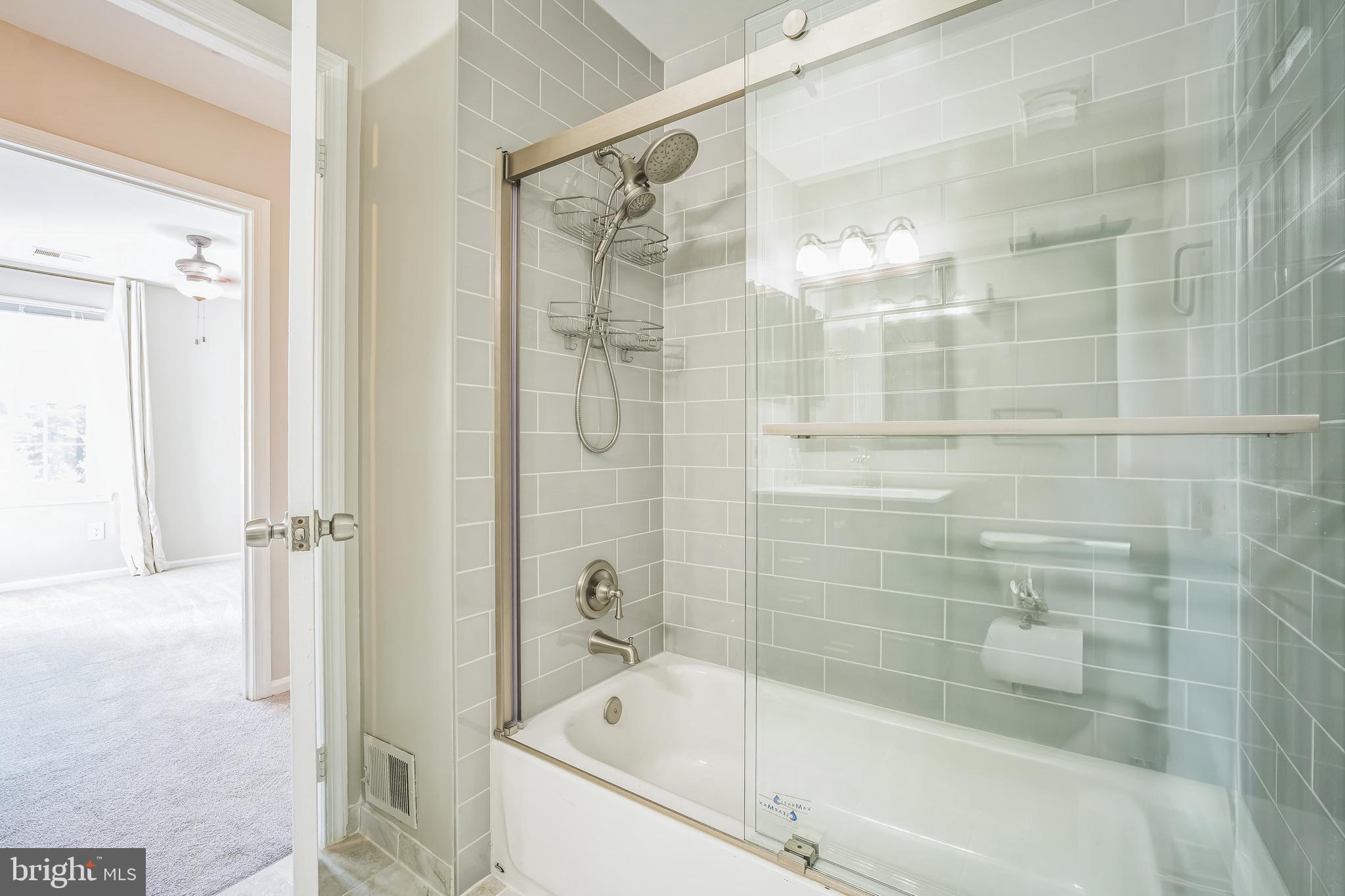14801 Basingstoke Loop Centreville, VA 20120 - Photo 18 of 28 a bathroom with a shower and bathtub