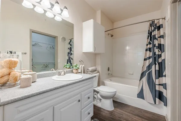 a white toilet sitting next to a bath tub