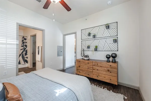 a bedroom with a bed and a chandelier