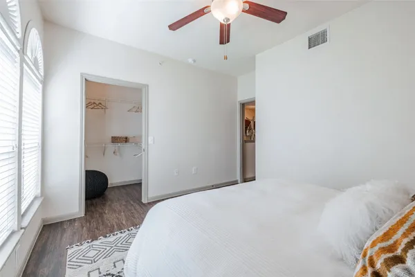 a bedroom with a large bed and a window