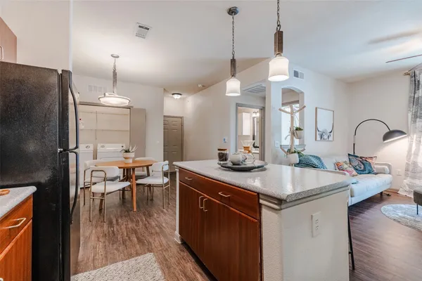 a kitchen with stainless steel appliances granite countertop a sink refrigerator and cabinets