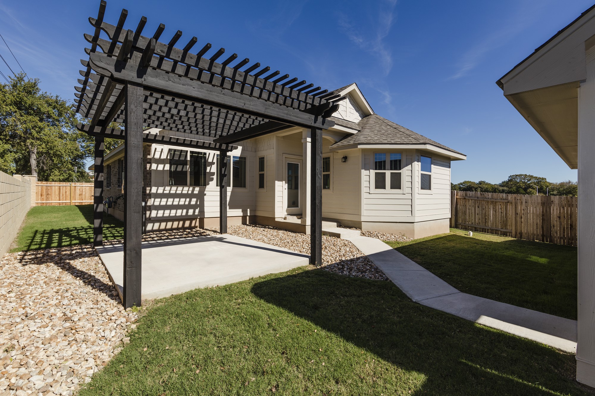 2725 Hopi Path Leander, TX 78641 - Photo 2 of 30 A private backyard oasis with a charming pergola and fresh landscaping.