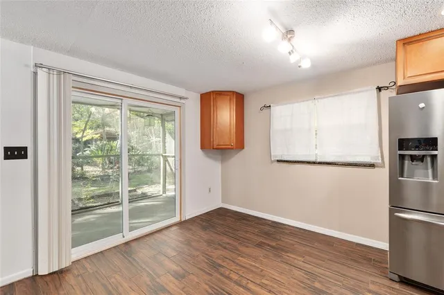 a kitchen with stainless steel appliances granite countertop wooden cabinets and a stove top oven