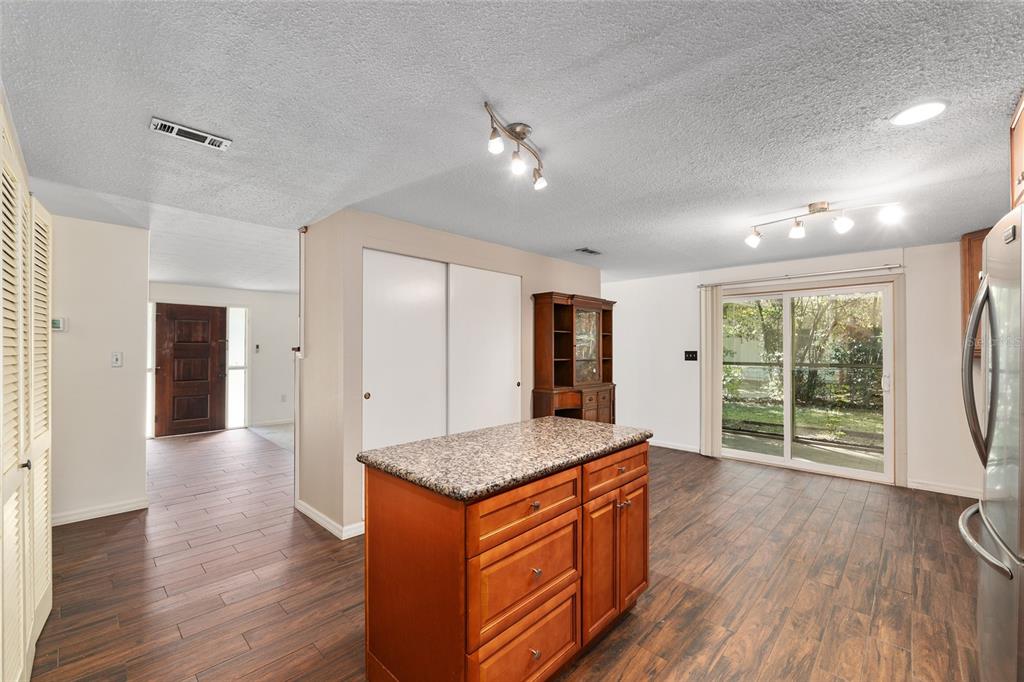 630 Northwest 34th Street Gainesville, FL 32607 - Photo 16 of 84 a kitchen with stainless steel appliances granite countertop a refrigerator a sink dishwasher and wooden floor