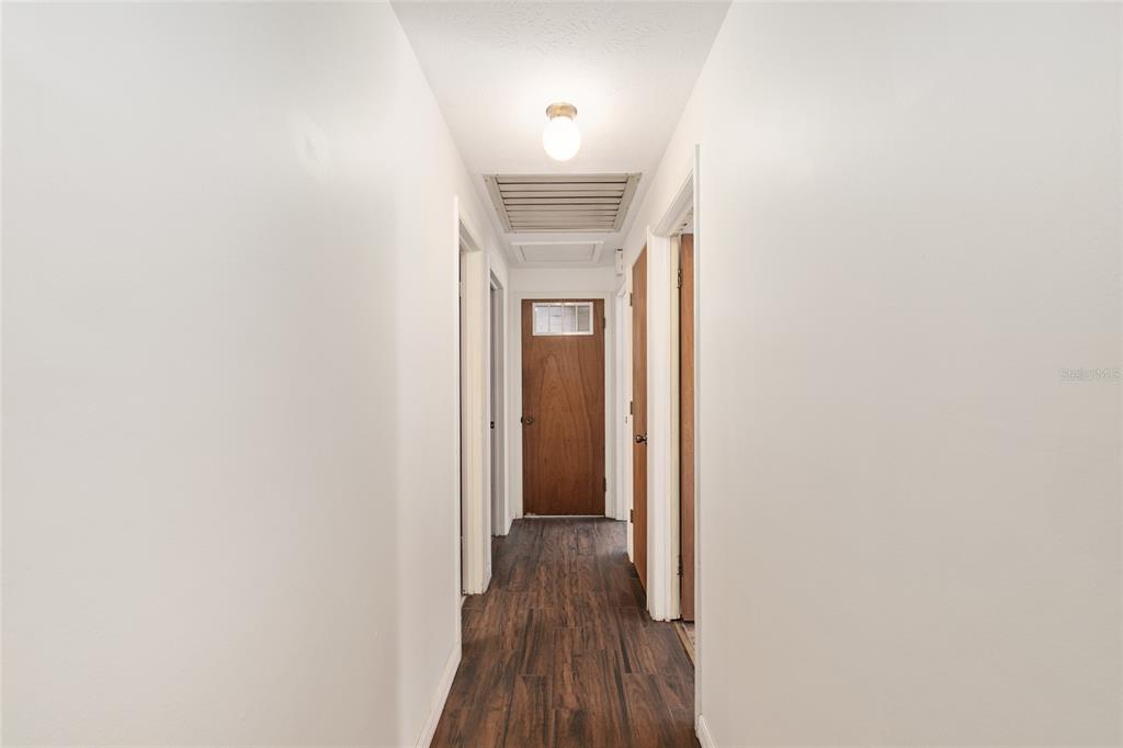 630 Northwest 34th Street Gainesville, FL 32607 - Photo 20 of 84 a view of a hallway with wooden floor and a bathroom