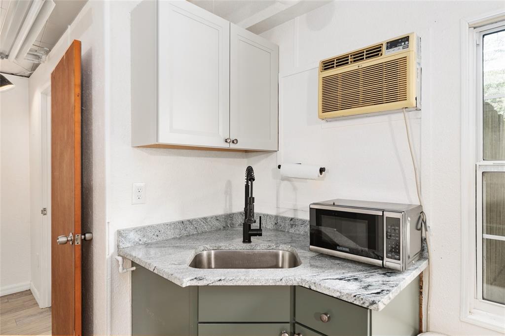 630 Northwest 34th Street Gainesville, FL 32607 - Photo 45 of 84 a kitchen with granite countertop a sink and a stove top oven