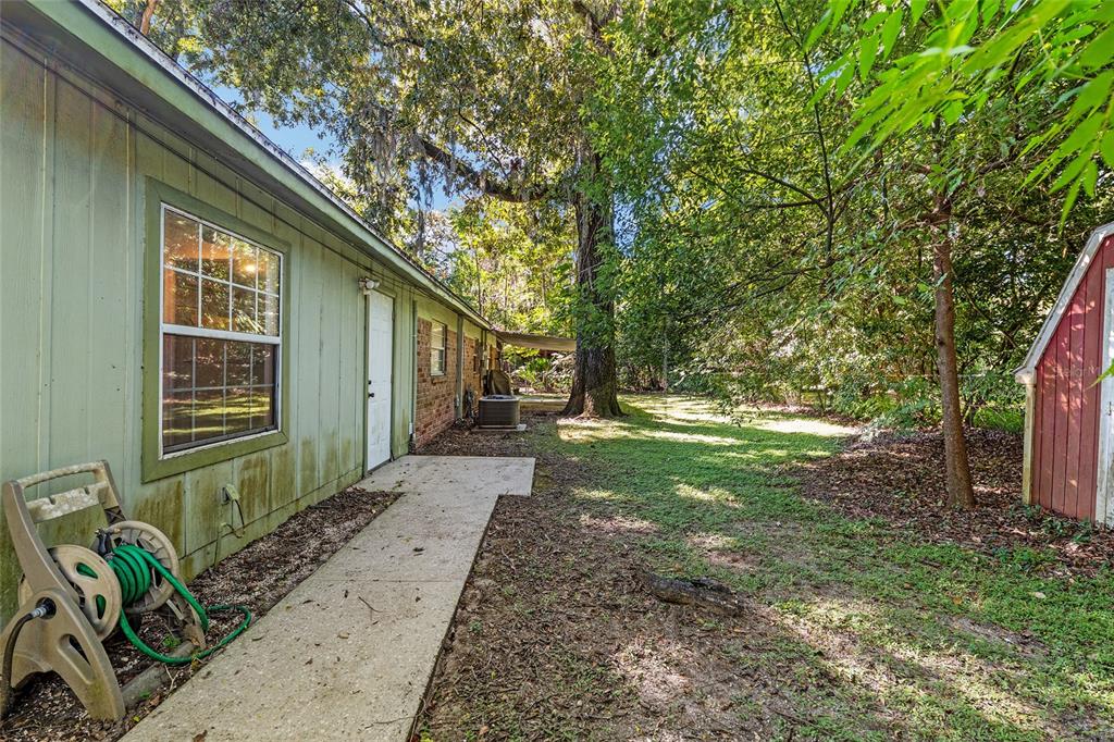 630 Northwest 34th Street Gainesville, FL 32607 - Photo 62 of 84 a backyard of a house with lots of green space