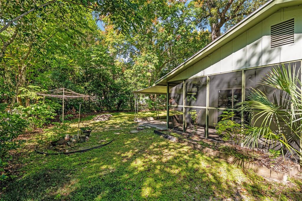 630 Northwest 34th Street Gainesville, FL 32607 - Photo 66 of 84 a backyard of a house with table and chairs and wooden fence
