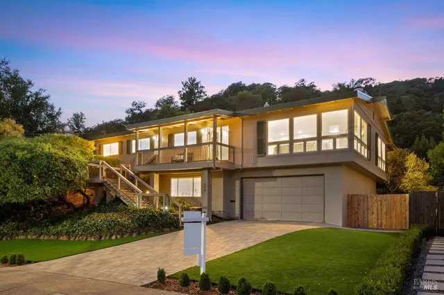 a front view of a house with a yard and garage