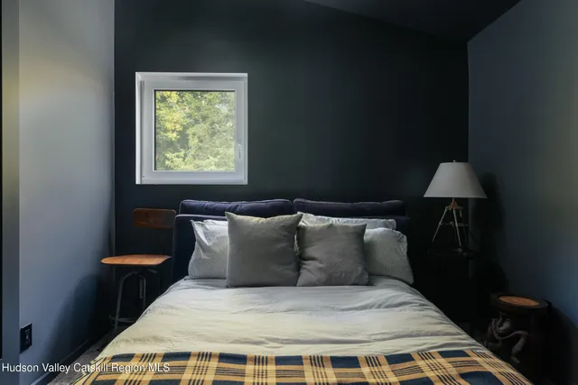 a bedroom with a bed and a window