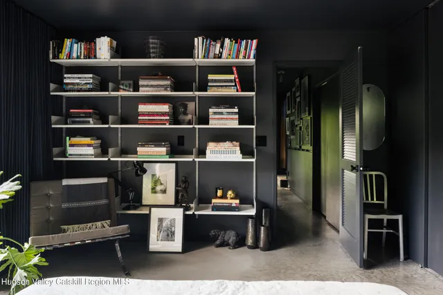a bedroom with a bed and a book shelf