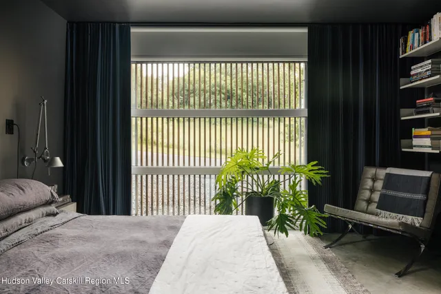 a bedroom with a bed and a flat tv screen