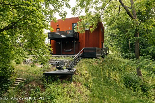 a view of a yard with plants and wooden fence