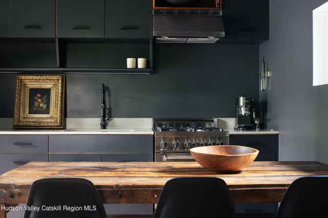 a room with a table chairs and a stove