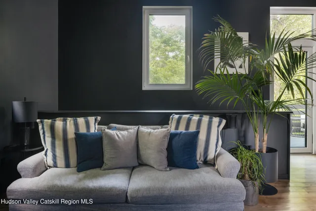 a living room with furniture and a potted plant