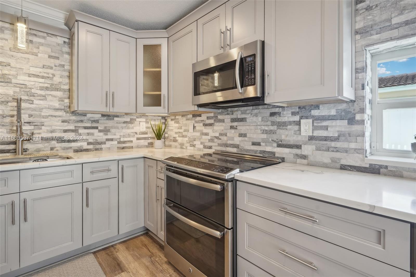 1164 Southwest 14th Street Boca Raton, FL 33486 - Photo 21 of 54 Gorgeous stone backsplash & pendant Light